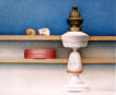 Wim Blom-Two sea shells on a shelf with oil lamp